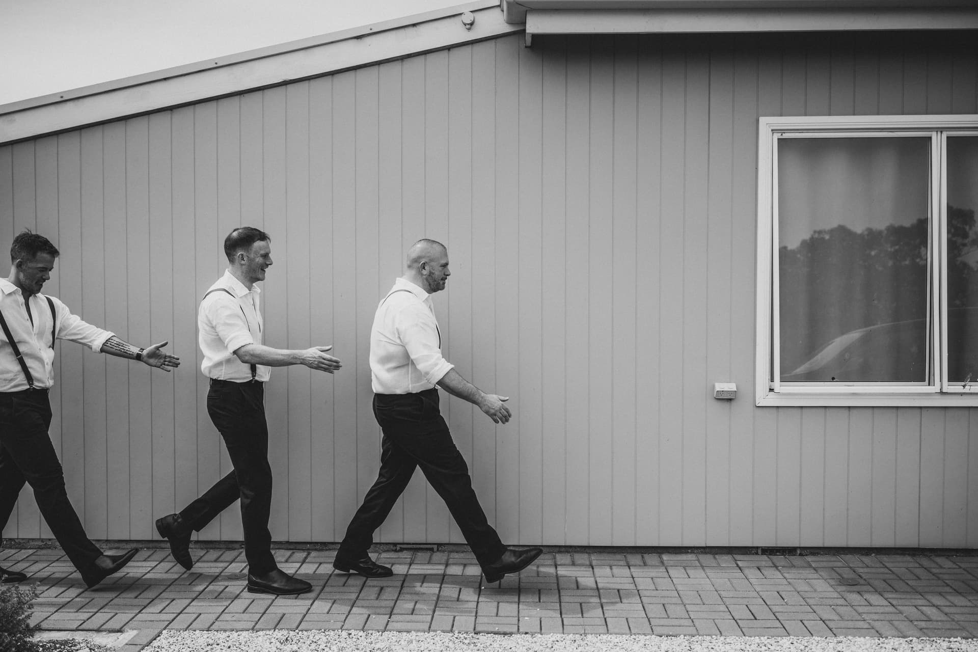 Groomsmen walking, black and white